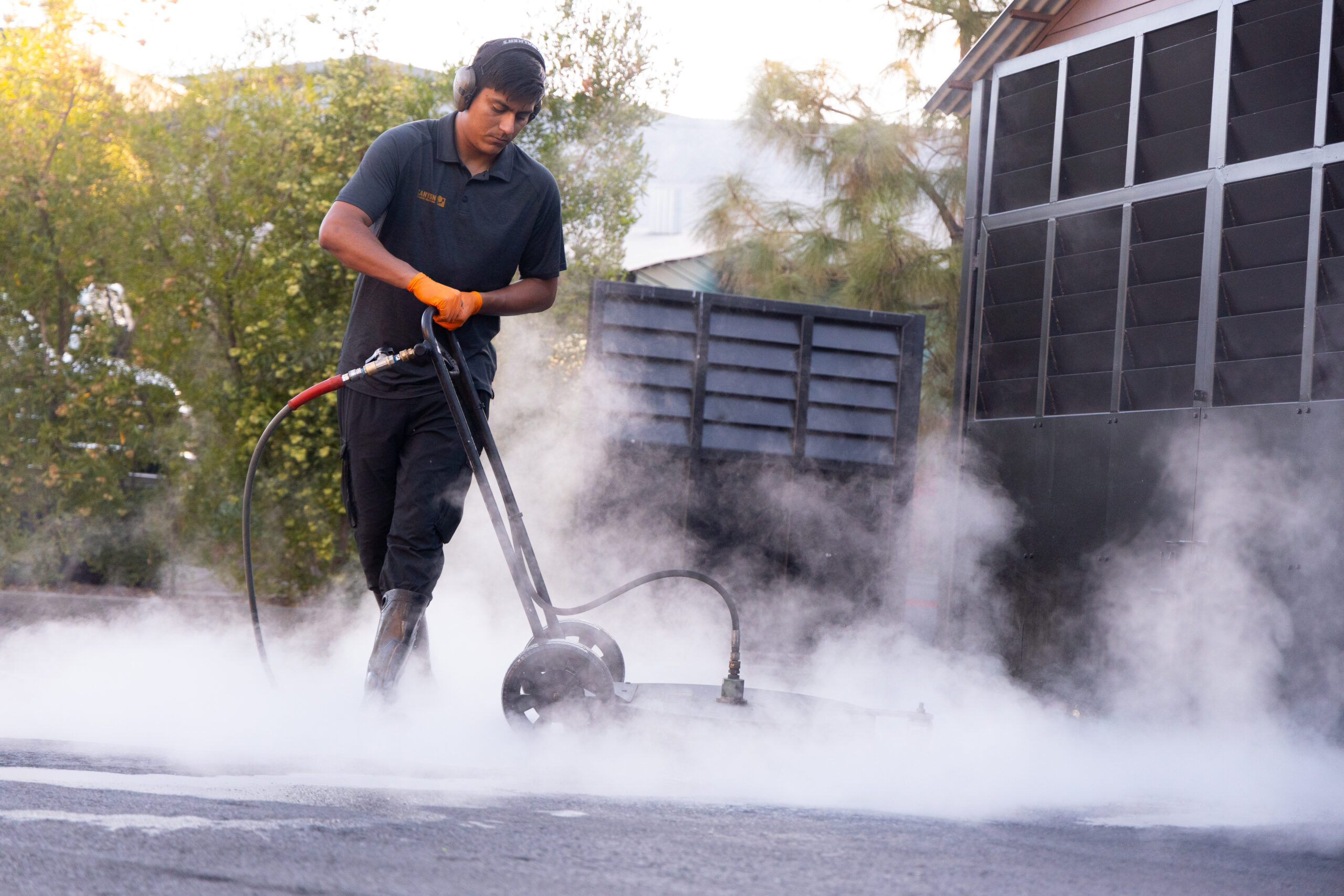 A photo of a Canyon Cleaning Solutions power washing professional power cleaning a business